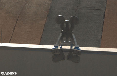 Mickey Sitting on the Edge of a Building