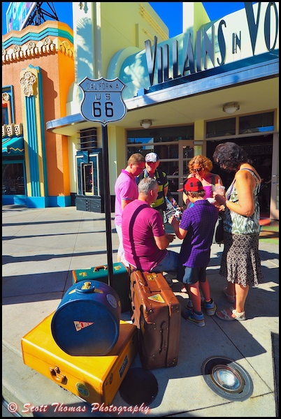Guests stop to ponder a map of Disney's Hollywood Studios on Route 66, Walt Disney World, Orlando, Florida.