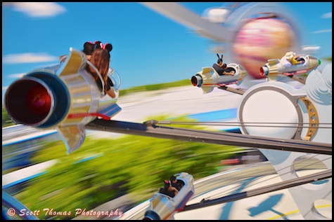 Riding the Astro Orbiter in Tomorrowland at the Magic Kingdom, Walt Disney World, Orlando, Florida.