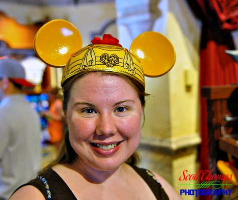 Young woman trying on a Belle Mickey Ears Hat in the Celebrity 5 & 10 shop at Disney's Hollywood Studios, Walt Disney World, Orlando, Florida