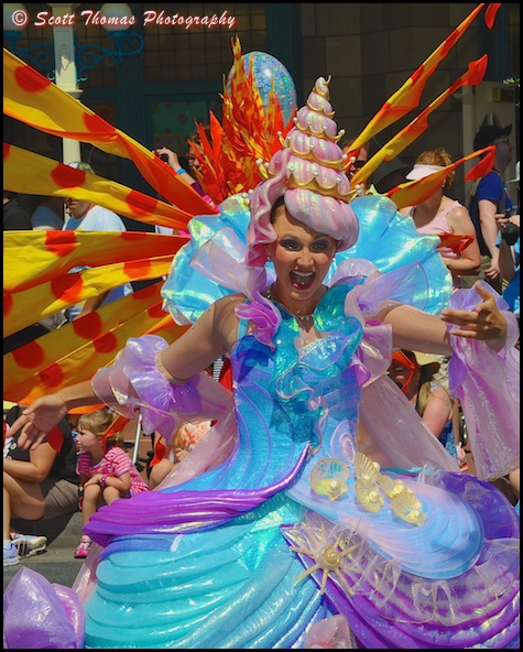 Colorful dancer preceding The Little Mermaid float in the Festival of Fantasy parade at the Magic Kingdom, Walt Disney World, Orlando, Florida