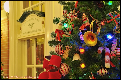 Main Street Railroad Station office behind a Christmas tree in the Magic Kingdom, Walt Disney World, Orlando, Florida