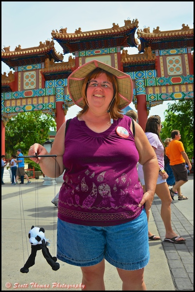 Vacationer posing at the China pavilion in Epcot, Walt Disney World, Orlando, Florida