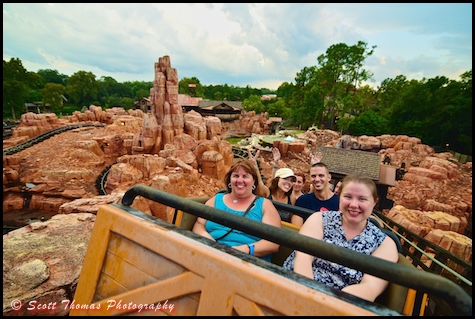 A family riding Big Thunder Mountain Railroad in Frontierland at the Magic Kingdom, Walt Disney World, Orlando, Florida