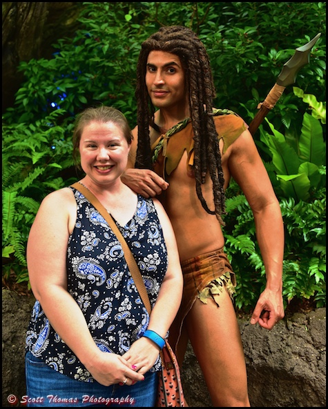 A young woman poses with Tarzan, the Ape Man, on one of the Discovery Island trails near the Tree of Life at Disney's Animal Kingdom, Walt Disney World, Orlando, Florida