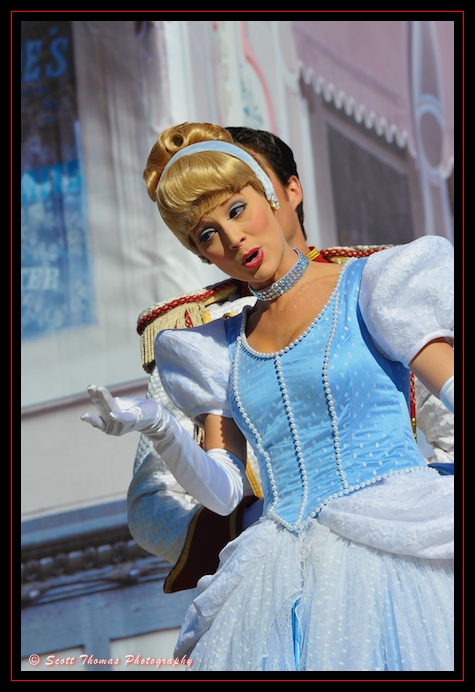 Princess Cinderella nods to guests during the Celebrate a Dream Come True Parade in the Magic Kingdom, Walt Disney World, Orlando, Florida. Princess Cinderella nods to guests during the Celebrate a Dream Come True Parade in the Magic Kingdom, Walt Disney World, Orlando, Florida.