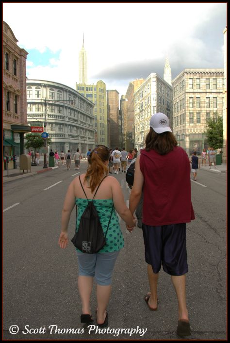 A young couple holding hands in Disney's Hollywood Studios, Walt Disney World, Orlando, Florida.