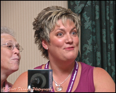 Surprise and suprised celebrity contestant, Jill, gets an assist from Deb Wills of AllEars.net during the Magic-Tunes game the night before MagicMeets in Harrisburg, Pennsylvania.