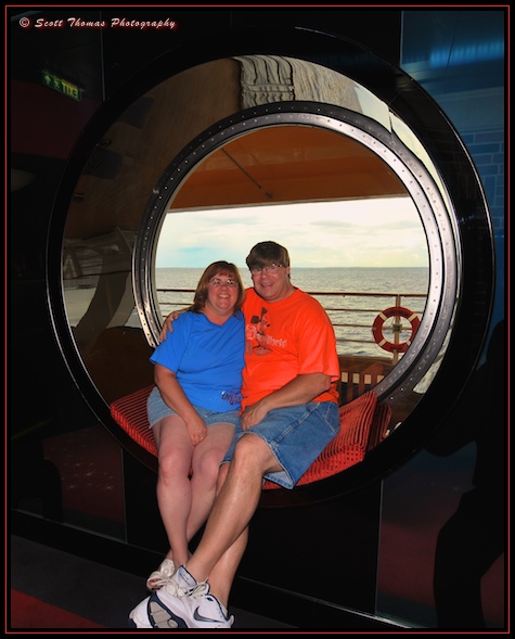 Scott and his wife sitting on a port hole in the District adult only nightclub area.