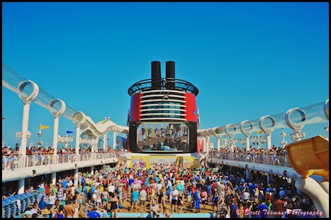 Passengers come out for the Sail Away Party show as the Disney Dream leaves Port Canaveral, Florida.