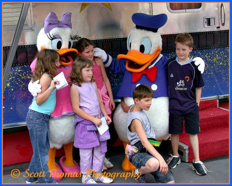 The spirit of Walt Disney can been seen in the faces of these children posing for their parents with Donald and Daisy Duck in Disney's Hollywood Studios, Walt Disney World, Orlando, Florida.