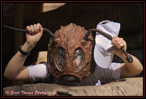 Kid looking through a bug eyed mask in Disney's Animal Kingdom, Walt Disney World, Orlando, Florida. Kid looking through a bug eyed mask in Disney's Animal Kingdom, Walt Disney World, Orlando, Florida.