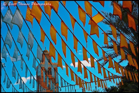 Katoubia Minaret prayer tower behind flags in Morocco's World Showcase pavilion in Epcot, Walt Disney World, Orlando, Florida