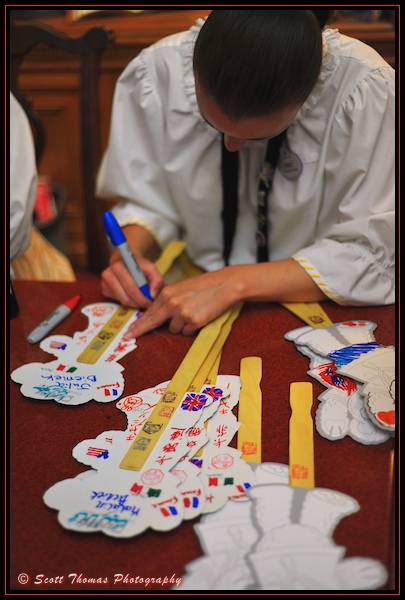 World Showcase Cast member decorates a Duffy cutout for a guest in Epcot's United Kingdom pavilion, Orlando, Florida