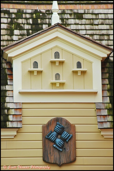 Four hands fire mark on a building in the Magic Kingdom's Liberty Square, Walt Disney World, Orlando, Florida.