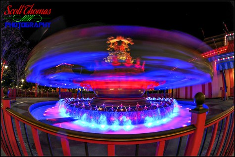 Dumbo, the Flying Elephant in motion at night in Fantasyland at Magic Kingdom, Walt Disney World, Orlando, Florida