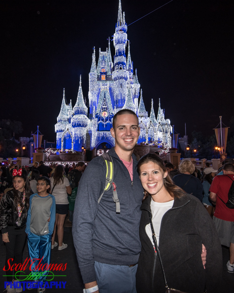 Couple portrait in the Magic Kingdom with Cinderella Castle lighted in the background, Walt Disney World, Orlando, Florida