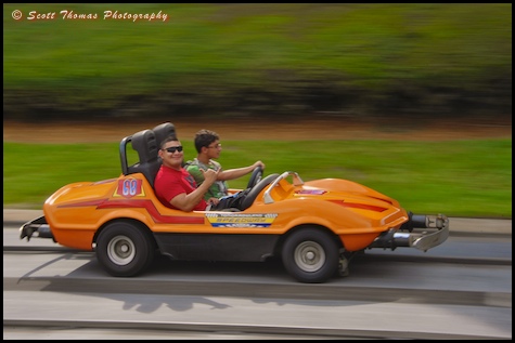 Guests speeding around the Tomorrowland Speedway in the Magic Kingdom, Walt Disney World, Orlando, Florida