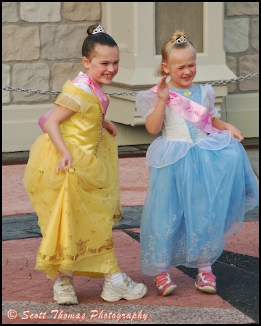 Two young princesses sporting the latest in royal footwear in the Magic Kingdom, Walt Disney World, Orlando, Florida.