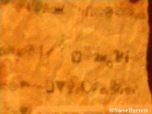 Adventurers Club tiny classic Mickey on the parchment hanging on the wall by the drink bar.