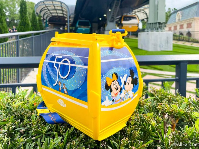 https://allears.net/wp-content/uploads/2022/05/2022-wdw-epcot-world-celebration-popcorn-stand-yellow-50th-anniversary-skyliner-gondola-popcorn-bucket-4-1-700x525.jpg
