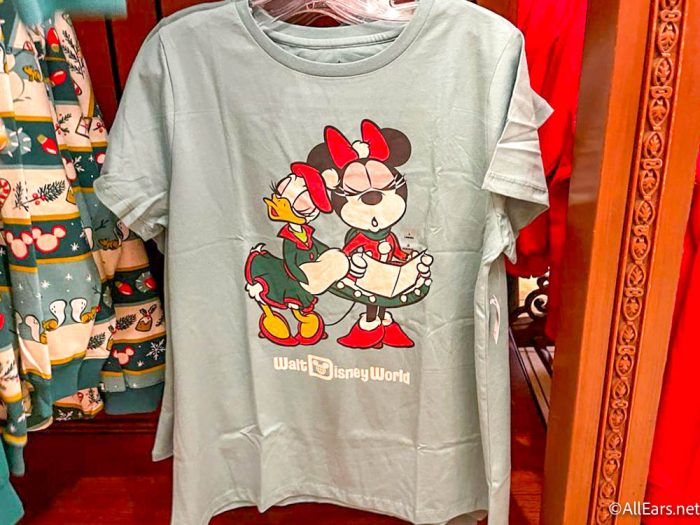 https://allears.net/wp-content/uploads/2022/10/2022-wdw-mk-the-emporium-holiday-merchandise-christmas-collection-minnie-daisy-carolers-singing-t-shirt-700x525.jpg