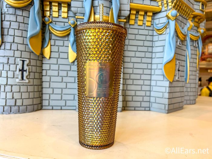 https://allears.net/wp-content/uploads/2023/03/2023-Magic-Kingdom-Gold-50th-Starbucks-Tumbler-1-700x525.jpg