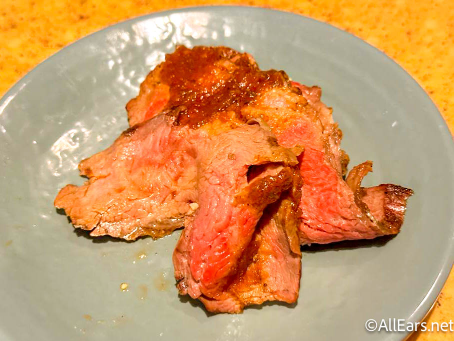 https://allears.net/wp-content/uploads/2023/06/wdw-2023-epcot-garden-grill-restaurant-breakfast-returning-flank-steak-with-chimichurri.jpg