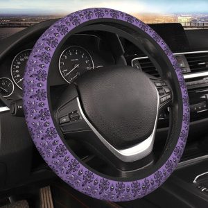 A purple and black steering wheel cover with a floral pattern, installed on the steering wheel of a car with a cityscape visible in the background.